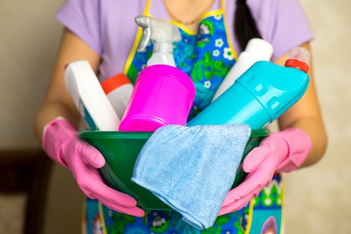 Cleaner maintaining a stairwell and hallway in a London communal area