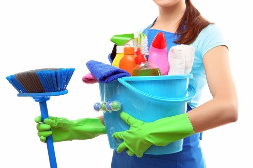 Local cleaning team working on windows, floors, and fixtures after building work in SW7